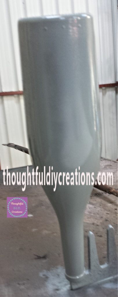 First layer of spray paint on the bottle.