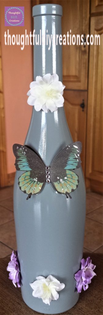 The flower heads hot glued to the altered bottle.