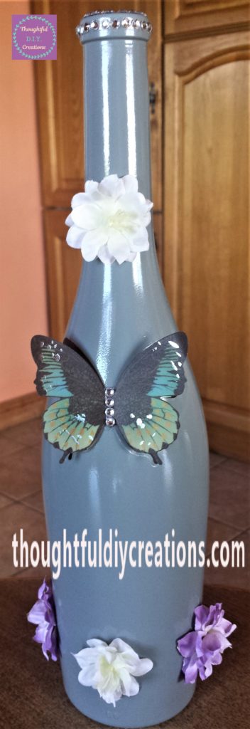 A strip of clear self-adhesive gemstones added to the top and side of the bottle.