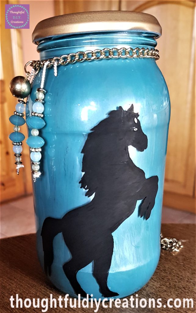 Beads and gold chain added to the jar and tied in a knot.