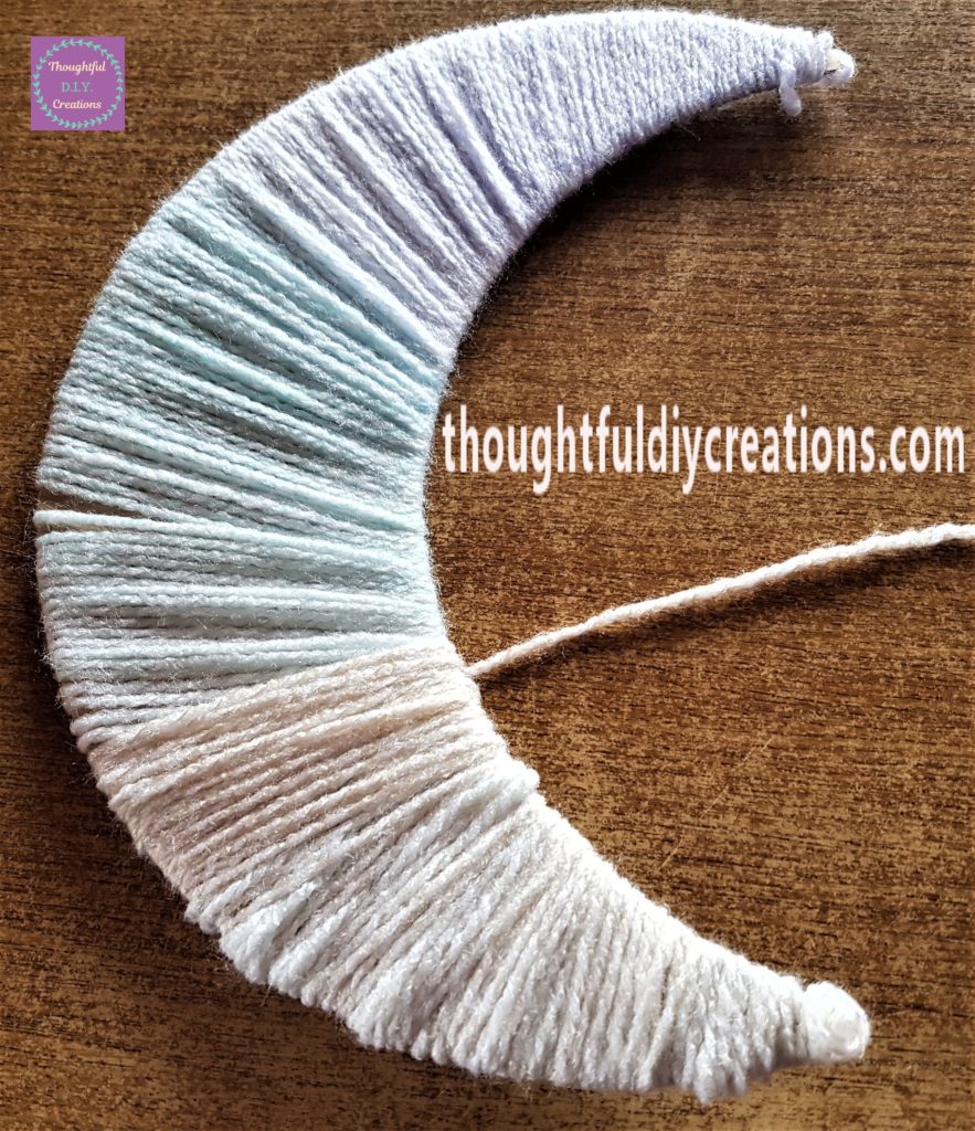 Filling in the gaps in the moon by adding more wool.