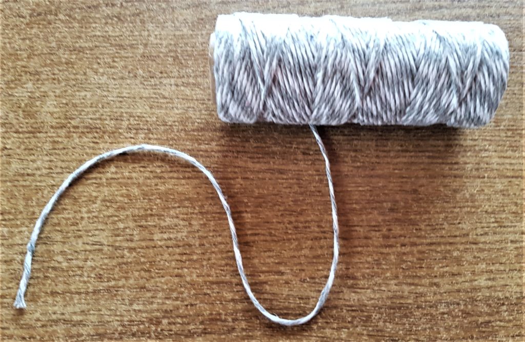 Roll of grey and white bakers twine.