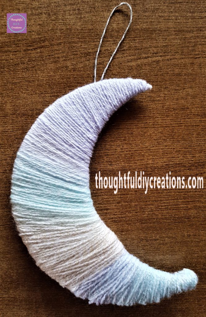 The grey and white twine in a loop hot glued to the back of the moon.