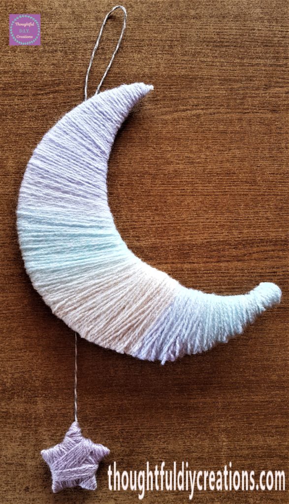 The grey and white twine hot glued to the back of the moon and hot glue added to the top half on the back of the star and attached to the bottom part of the string.