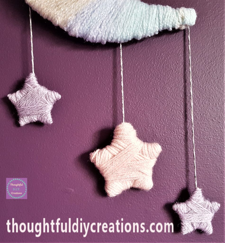 Close up image of the string and stars hung up on the wall.