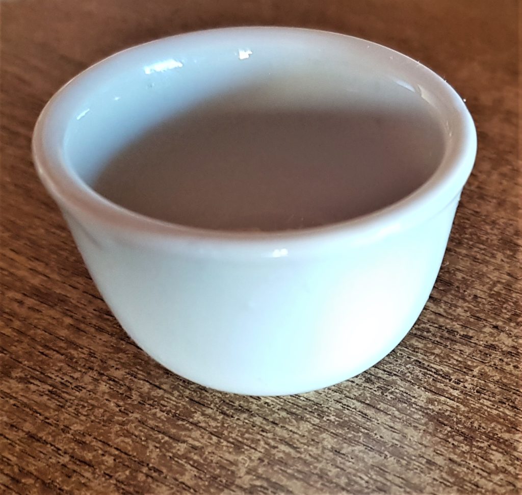 Small white glass candle holder.