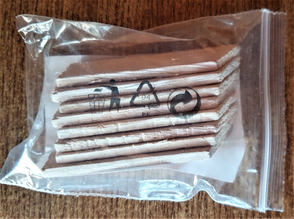 A packet of small wooden pieces that came with a Canvas.