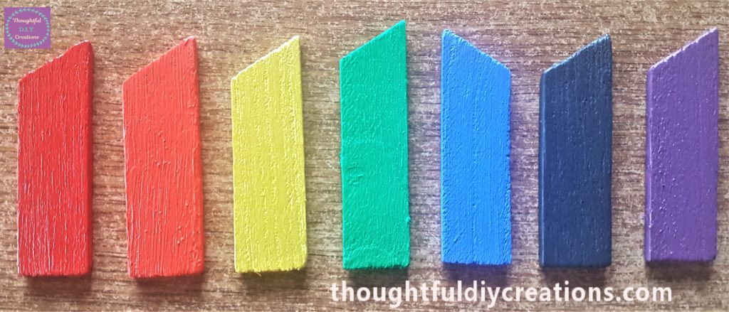 The second layer of paint applied to the wooden pieces.