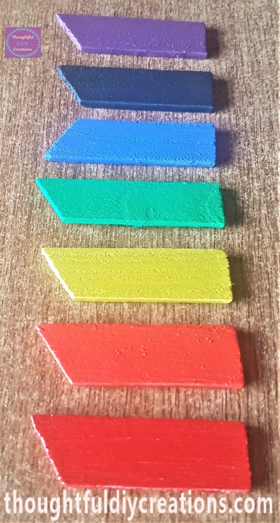 The third and final layer of paint added to the wooden pieces.