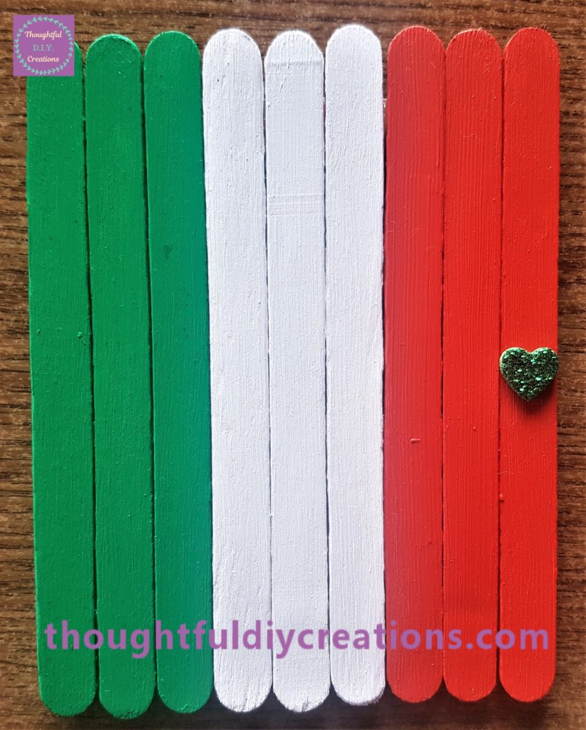 The green heart sticker attached to the leprechaun door for a door knob.