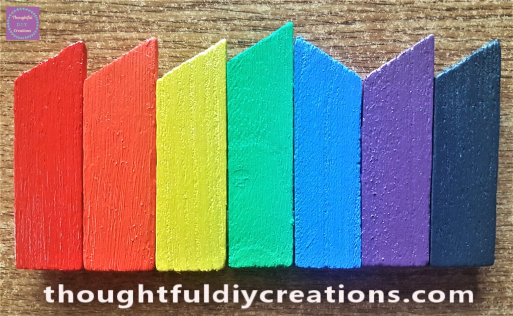 The rainbow path standing upright with the lollipop sticks glued to the back of it.