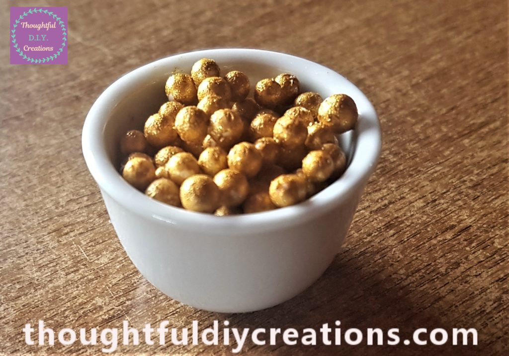 The gold mini balls in the candle holder.