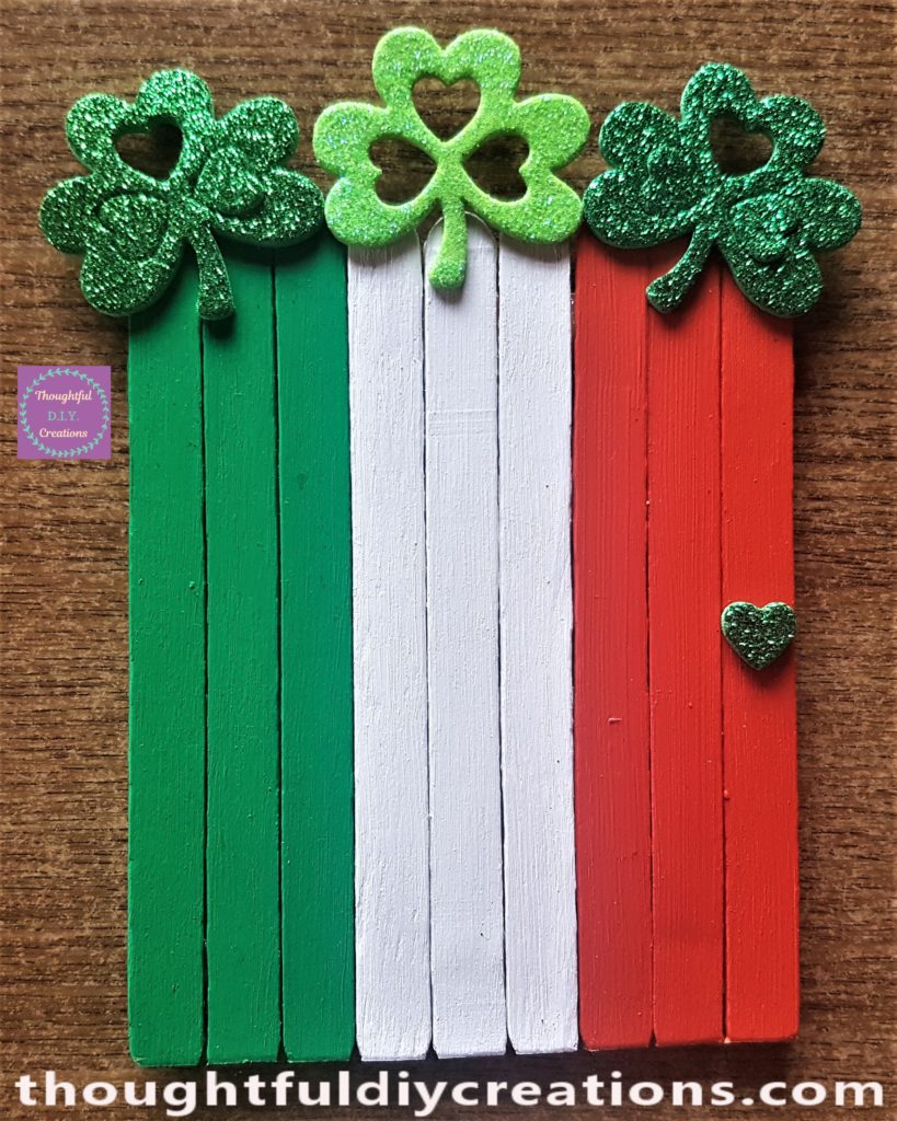 3 shades of green foam shamrock stickers attached to the top of the leprechaun door.