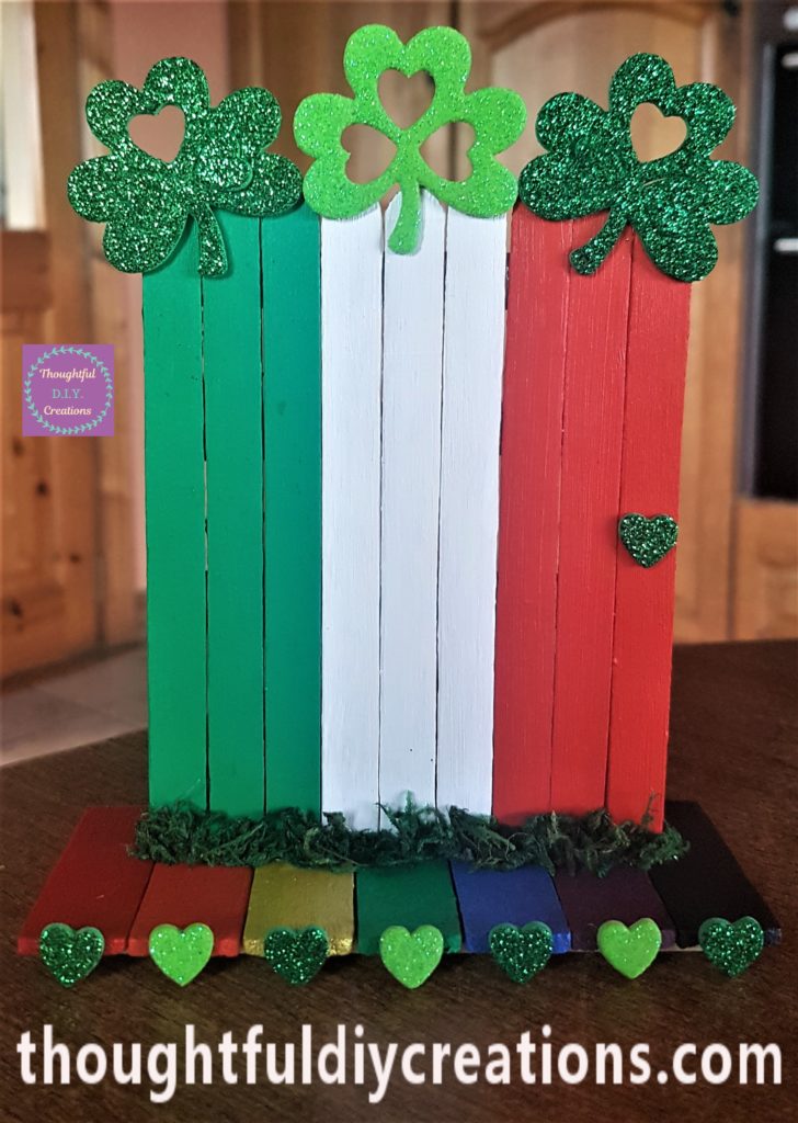 Full view of the leprechaun door with moss attached to the front and sides.