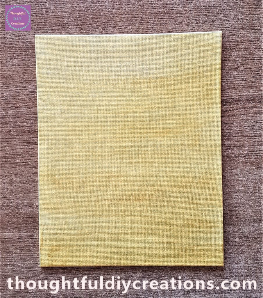First layer of gold paint on the canvas board.