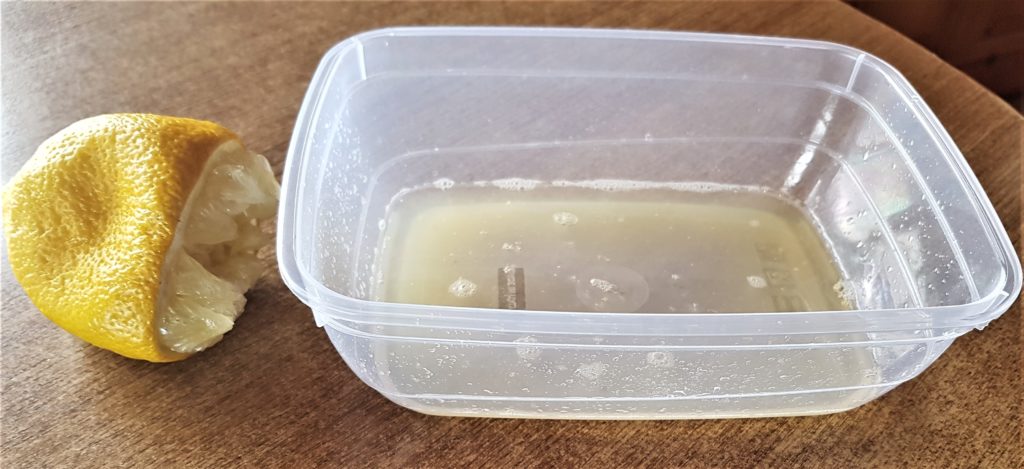 The juice of almost 1 full lemon squeezed into a container.