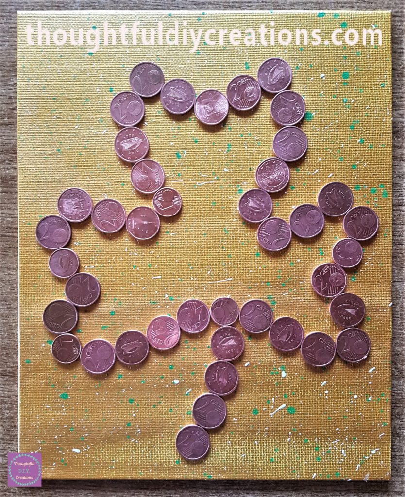 The outline of coins attached to the canvas.