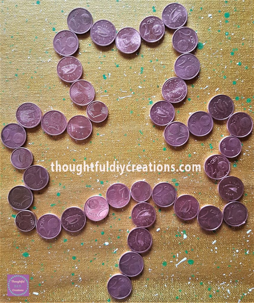 A close-up image of the coins on the canvas.