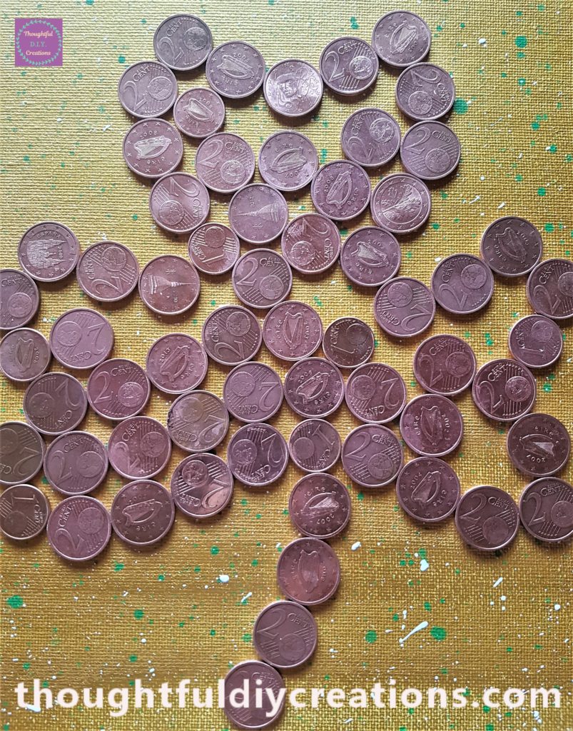 A close-up image of the coins glued to the inside of the shamrock.