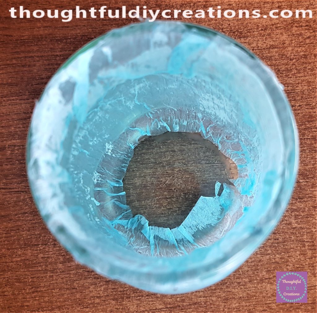 View of the inside of the jar with blue crepe paper smoothed to the jar.