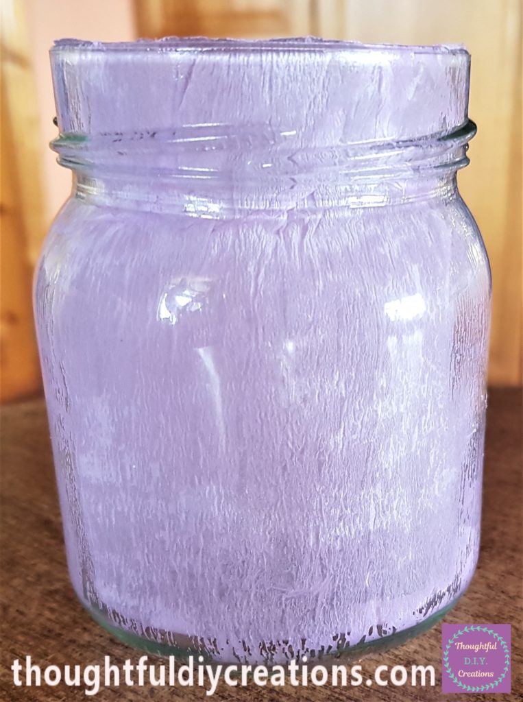 Pink crepe paper glued to the inside of the other small jar.