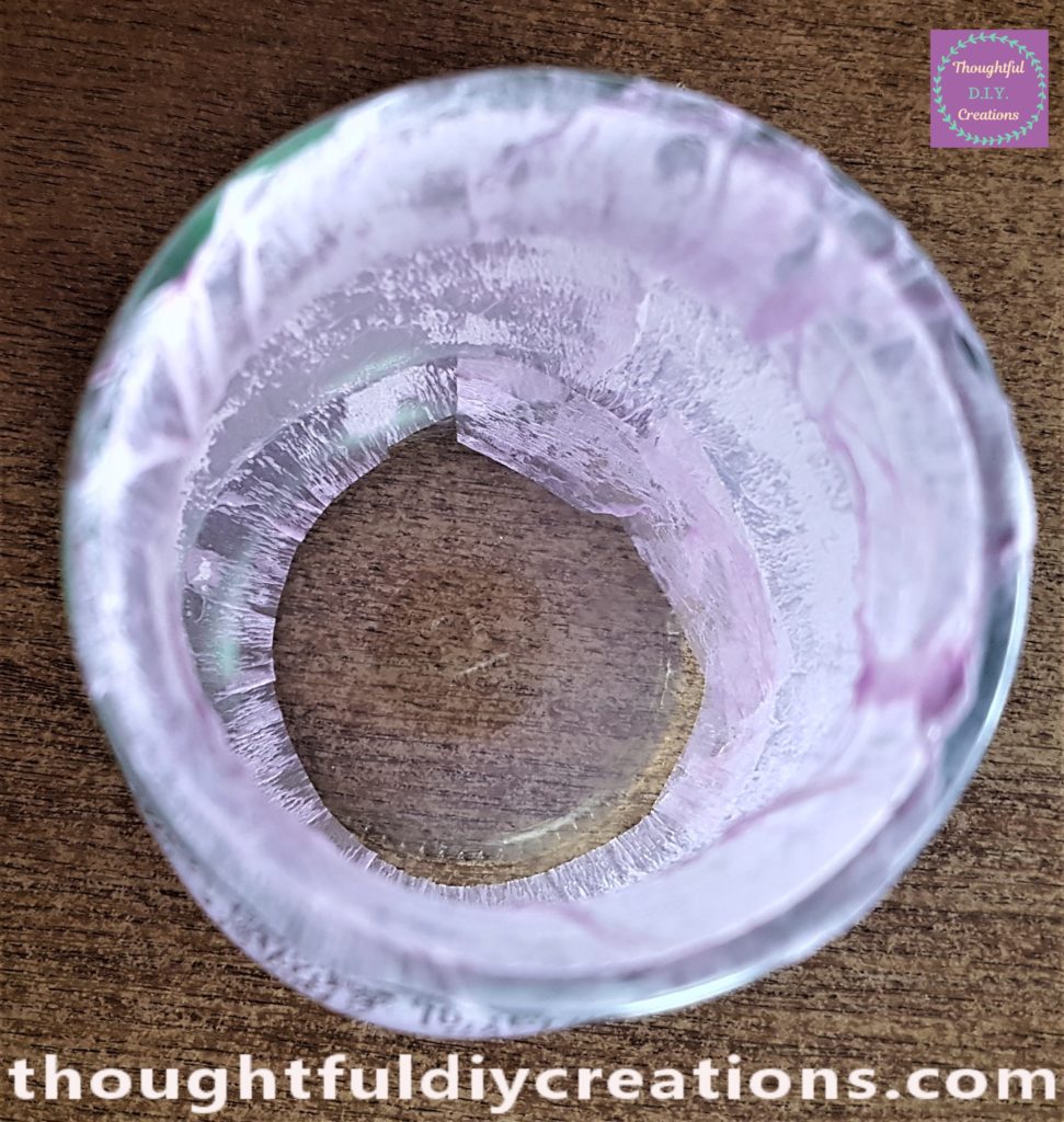 View of the inside of the jar with pink crepe paper glued to the jar.
