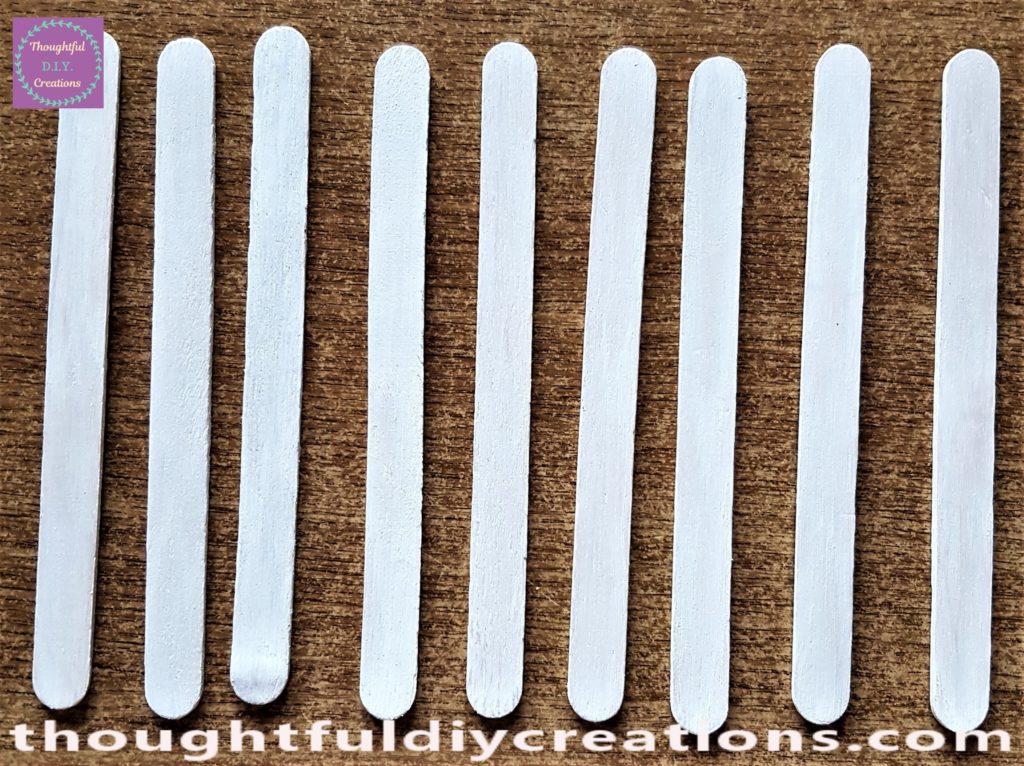 The second layer of paint on the lollipop sticks.