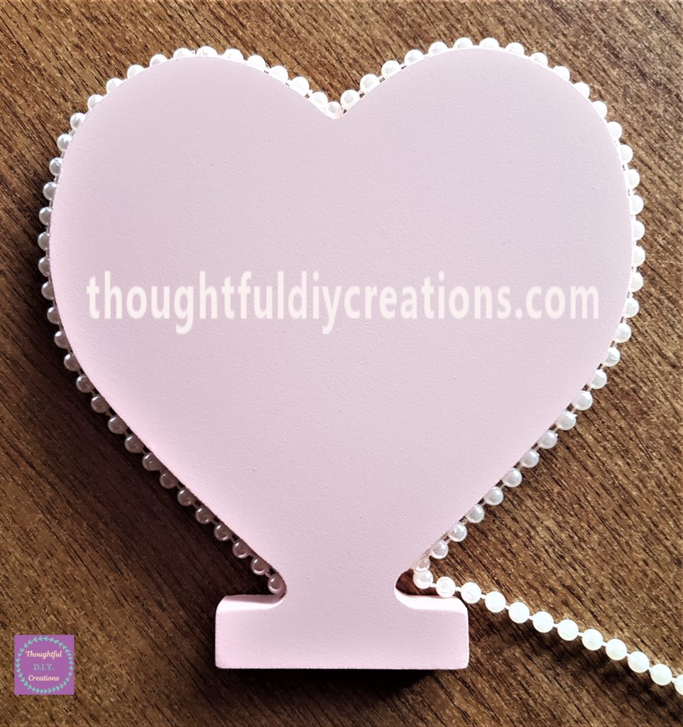 Both sides of the heart covered with the pearl garland.