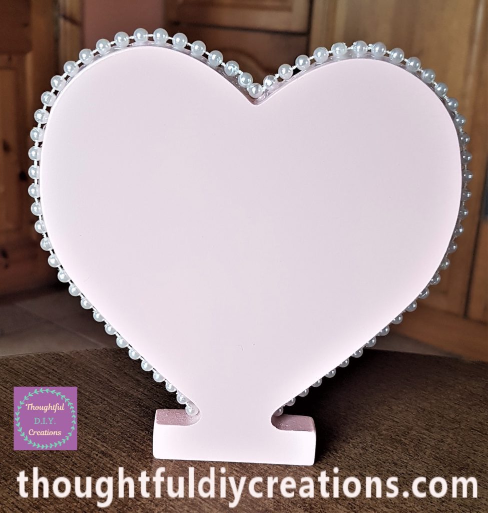 The excess pearls cut off and hot glue added to the last pearl on the heart.