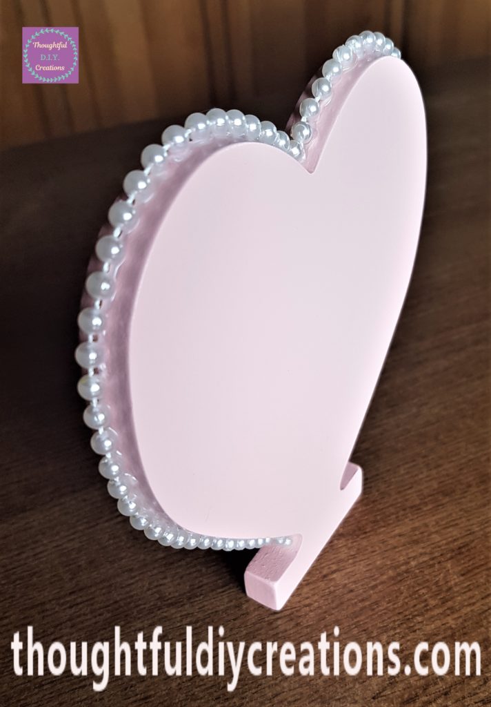 Side view of the heart with pearls attached.