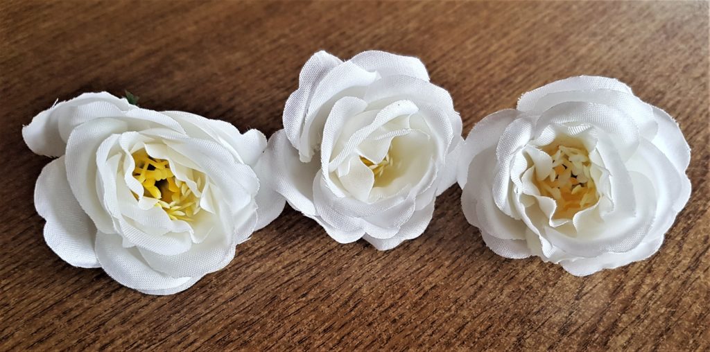 The heads of 3 artificial flowers.