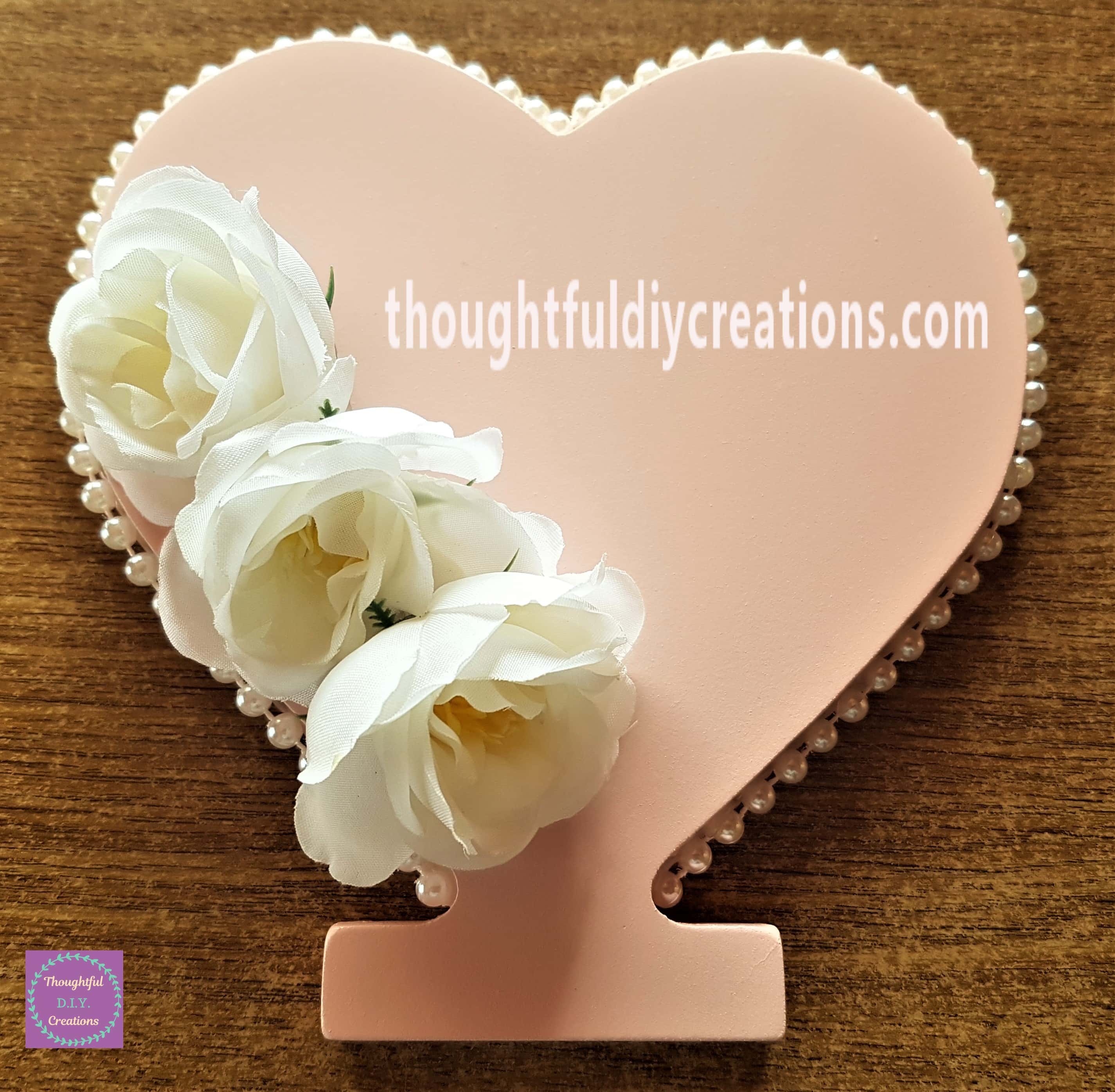 The second and third flowers hot glued to the heart under the first flower.