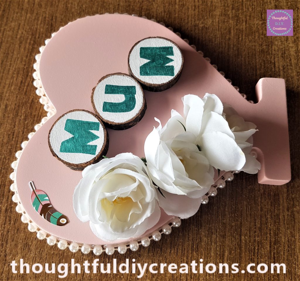 Feather sticker attached to the top left hand side of the heart.