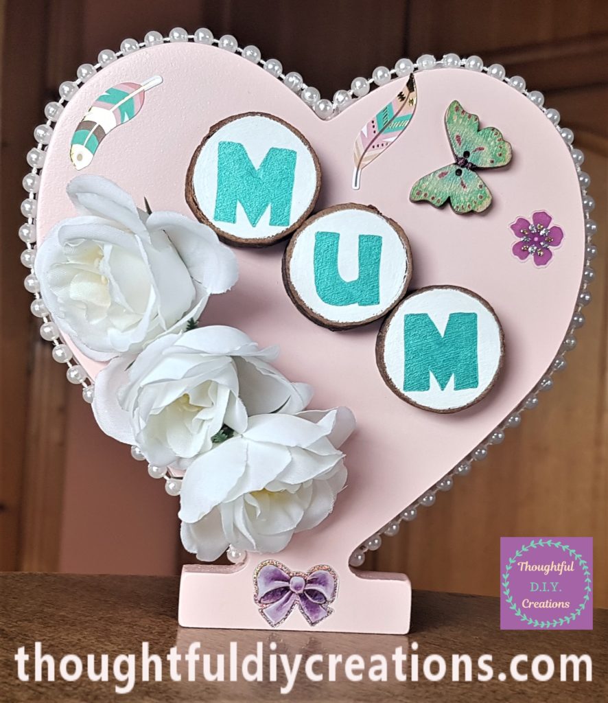 The heart standing upright with the flower sticker added to it.