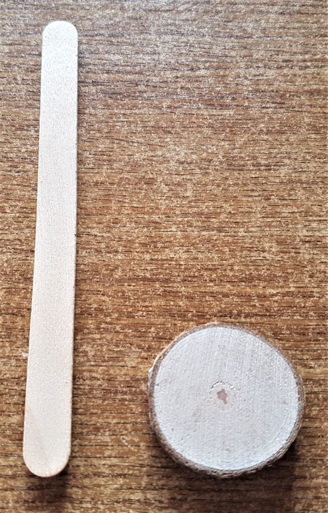 Lollipop stick and a small wood slice.