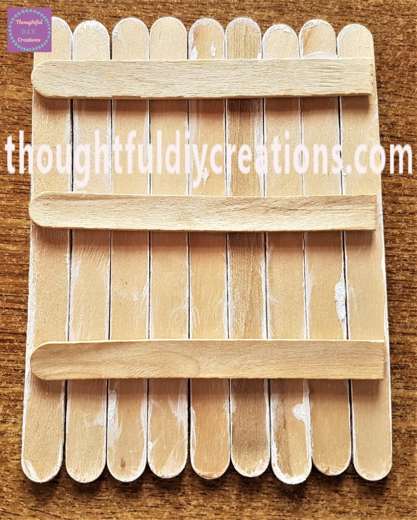 The 3 cut lollipop sticks hot glued to the back of the Easter Bunny Door.