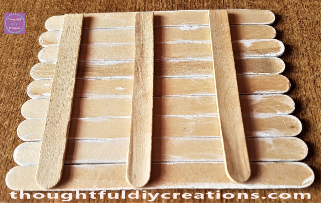 Side view of the 3 lollipop sticks hot glued to the Easter Bunny Door.