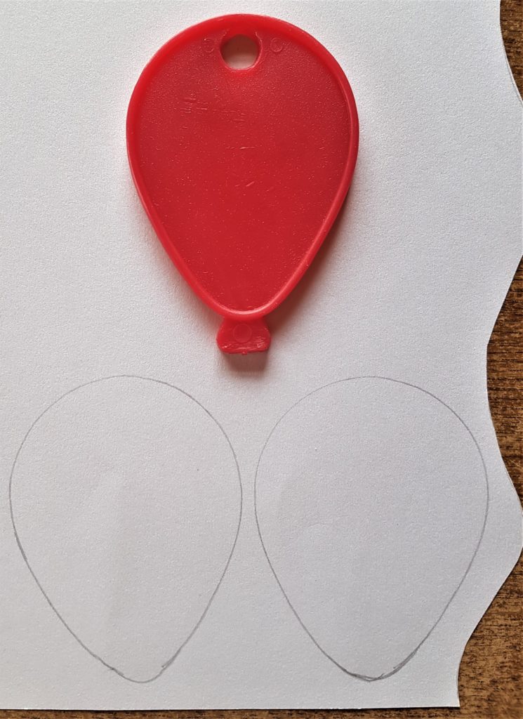 Plastic Balloon Template used to get the shape of the Bunny Ears on the back of the lace paper.