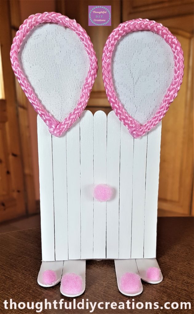 Hot glue on the back of a pom pom and attached to the Door for a nose.