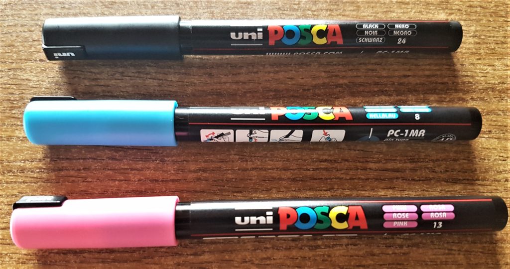 uni POSCA Paint Pens 0.7 mm in Black, Blue and Pink.