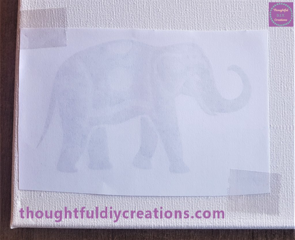 Close up image of the elephant sellotaped onto the canvas.