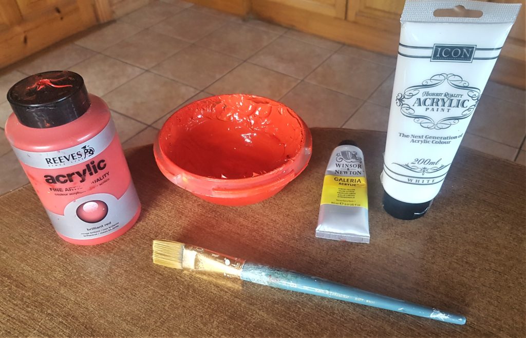 Red, orange, yellow and white acrylic paint for the sunset. Red and yellow paint mixed together to get orange. A flat 1 inch paintbrush.