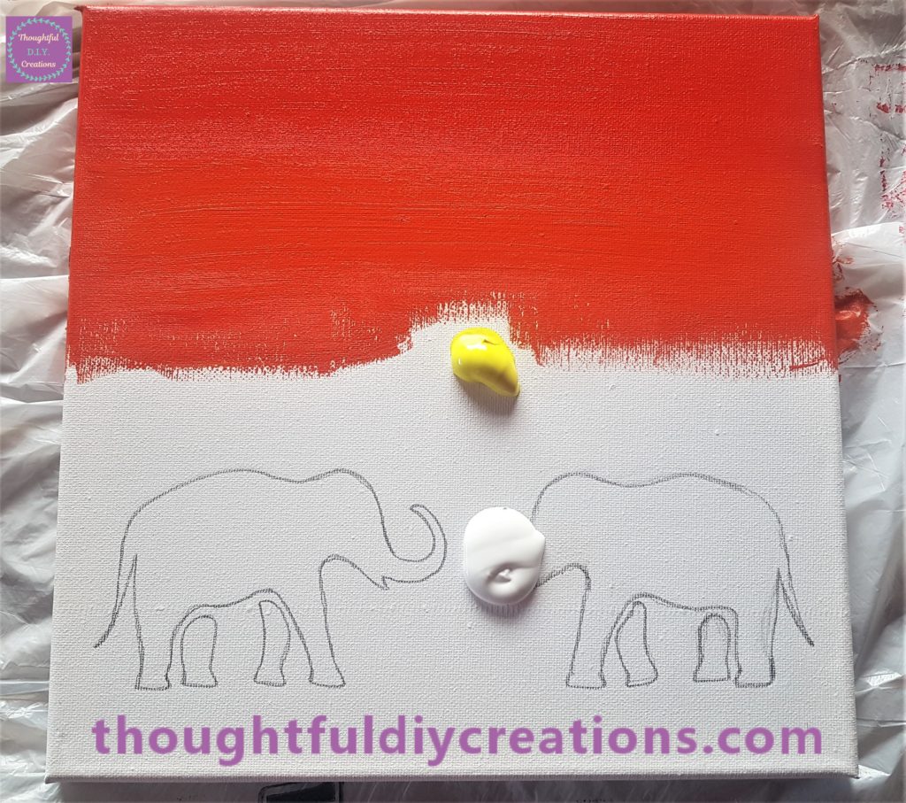 The orange section of the sunset blended with the red on the canvas.