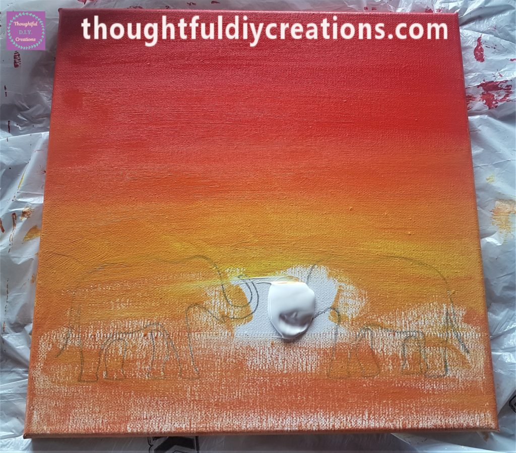 The yellow paint blended with the orange and spread evenly to the bottom of the canvas.