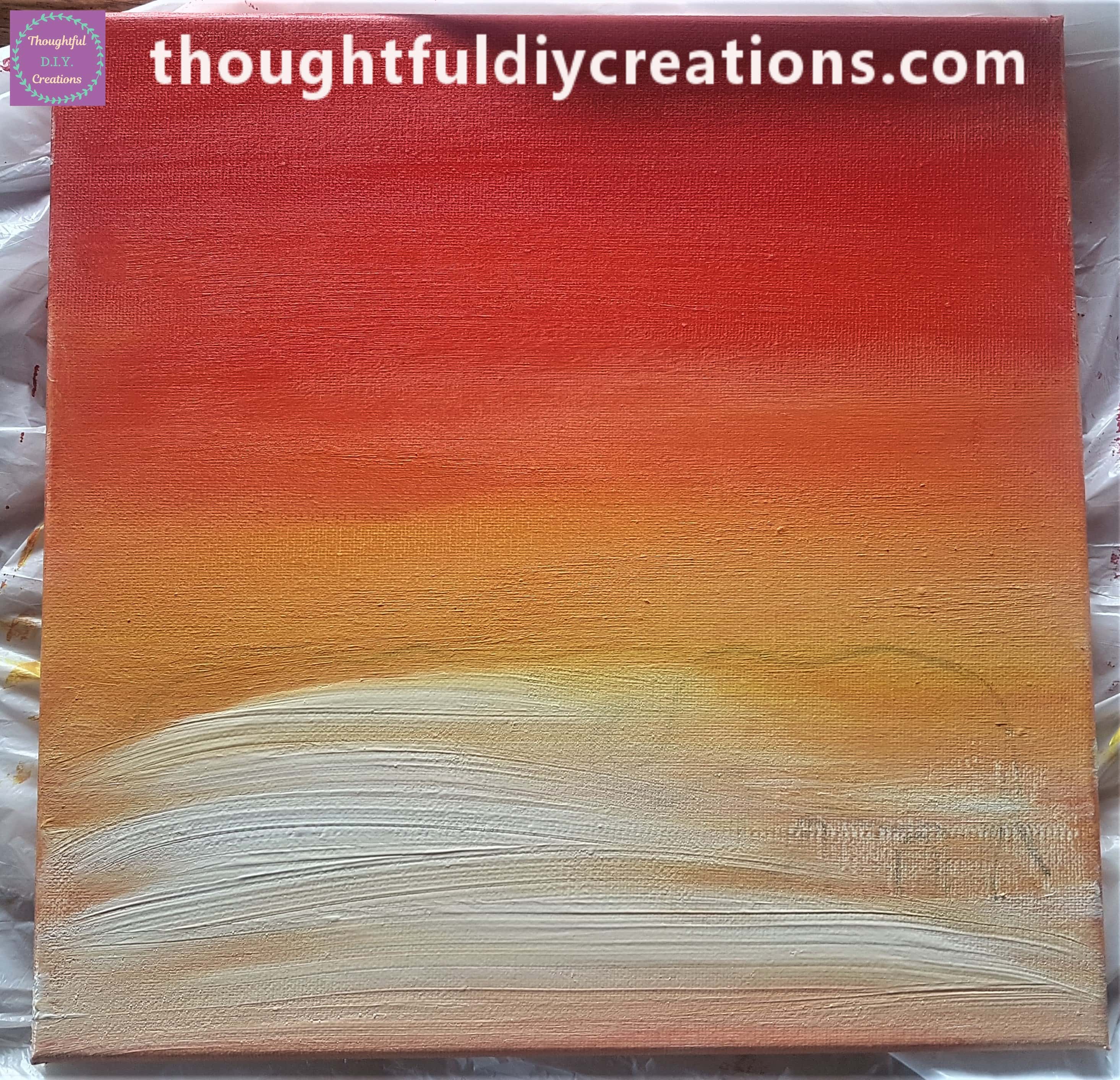 White paint beginning to be spread across the canvas.