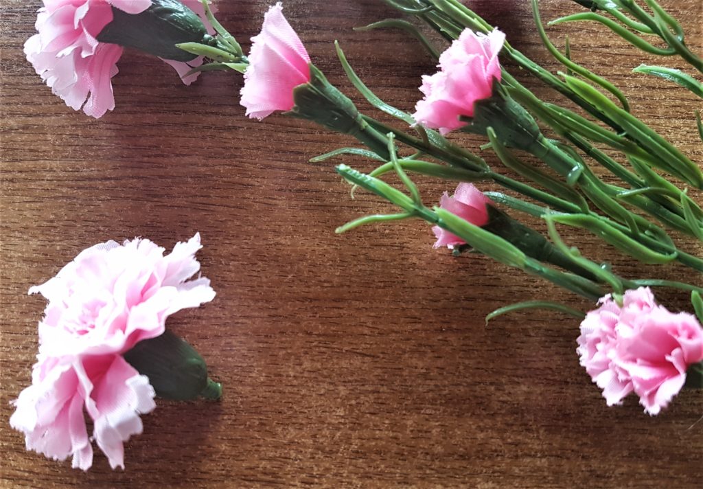 A pink flower head pulled from it's stem.