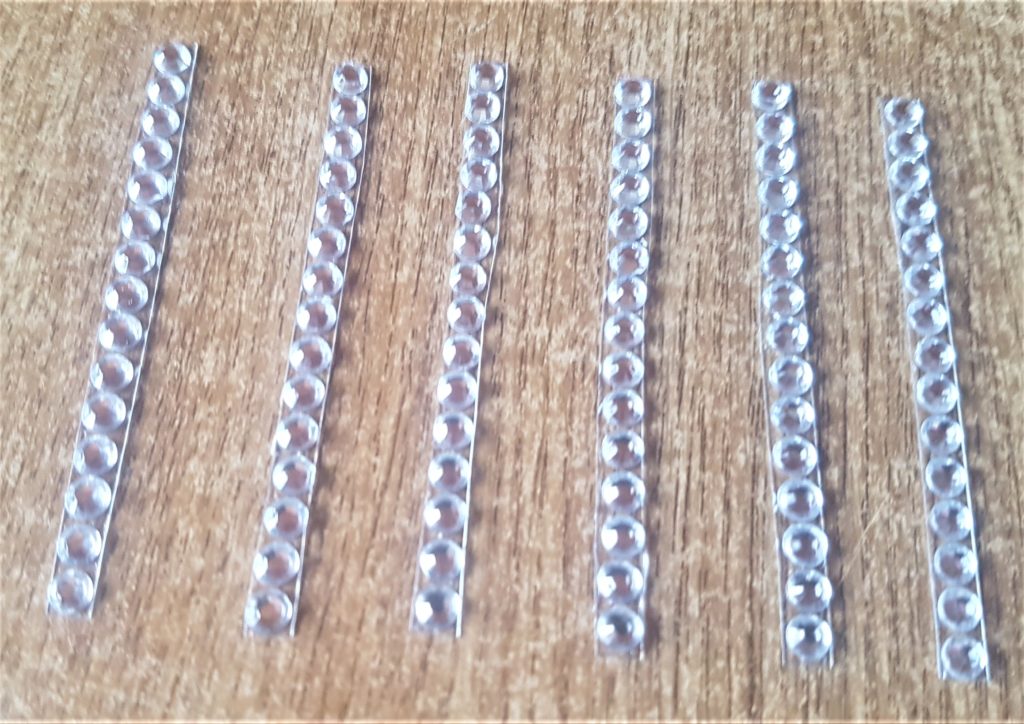 Gemstones cut into strips to make it easier to attach them.