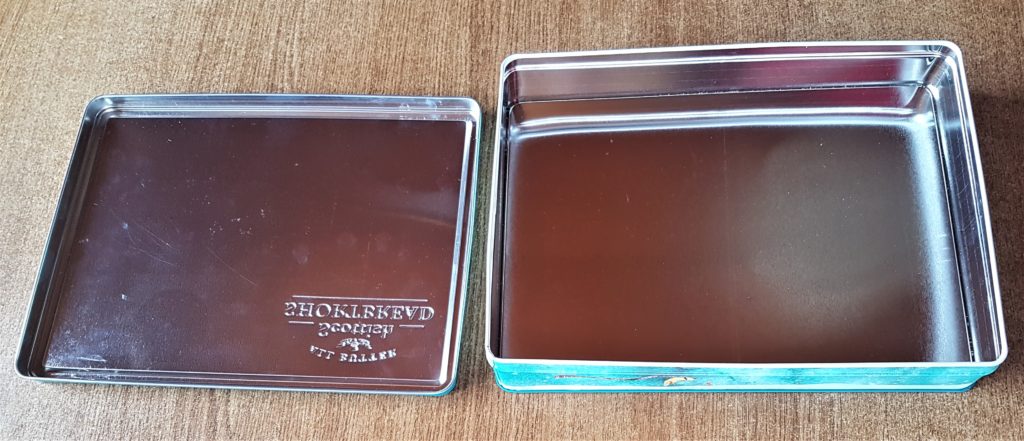 Lid off the Biscuit Tin and the view of the inside before it was turned into a Fairy Garden.