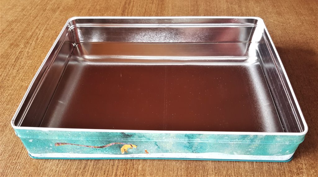 Inside of the biscuit tin before being up-cycled.