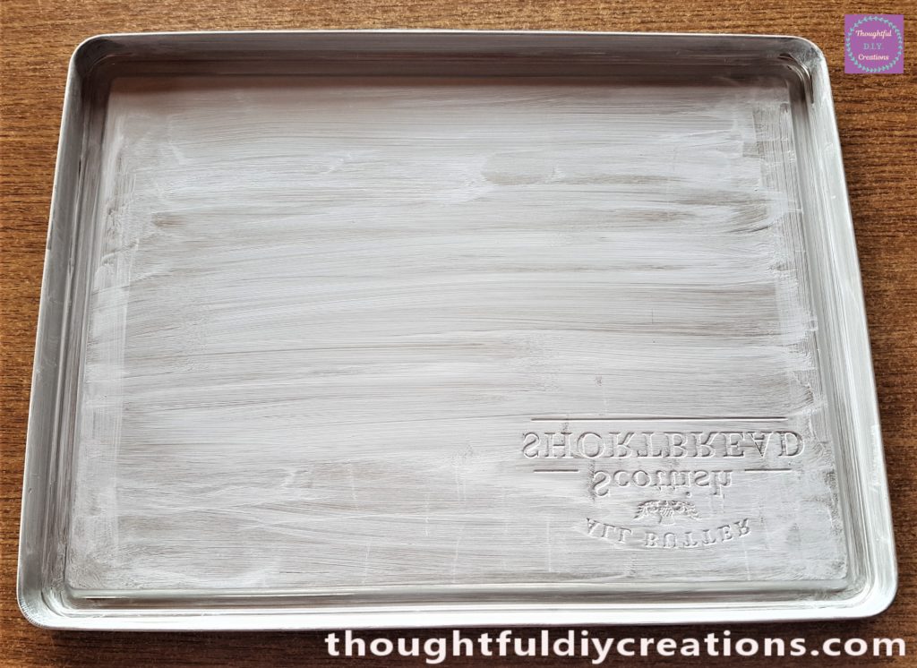 A close-up of the lid after the first layer of Gesso.